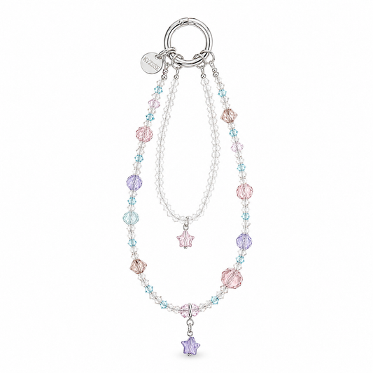 A double-strand beaded charm bracelet with a silver-tone ring clasp. One strand features clear beads, and the other is adorned with pastel pink, light blue, and lavender purple beads, including flower and star charms.