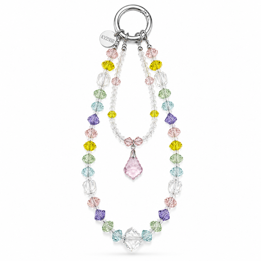 A crystal and bead necklace with a silver-tone ring clasp, featuring multicolored faceted beads in pink, yellow, green, blue, and purple, a small pink bow detail, and a large clear teardrop crystal pendant.